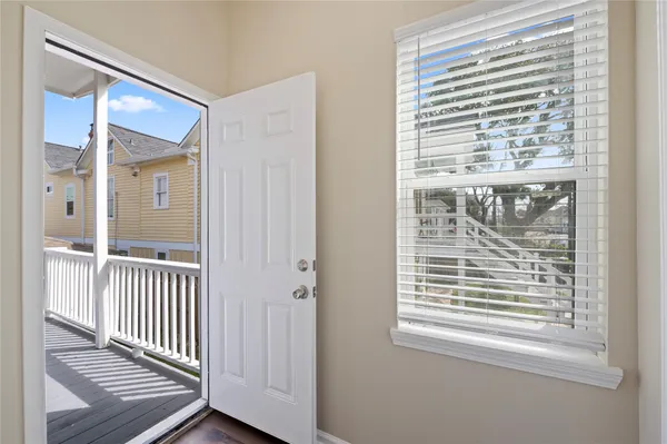 a view of a room with wooden floor and windows
