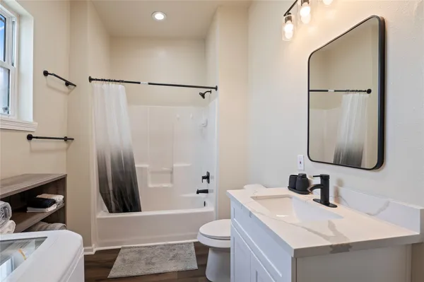 a bathroom with a sink toilet and shower