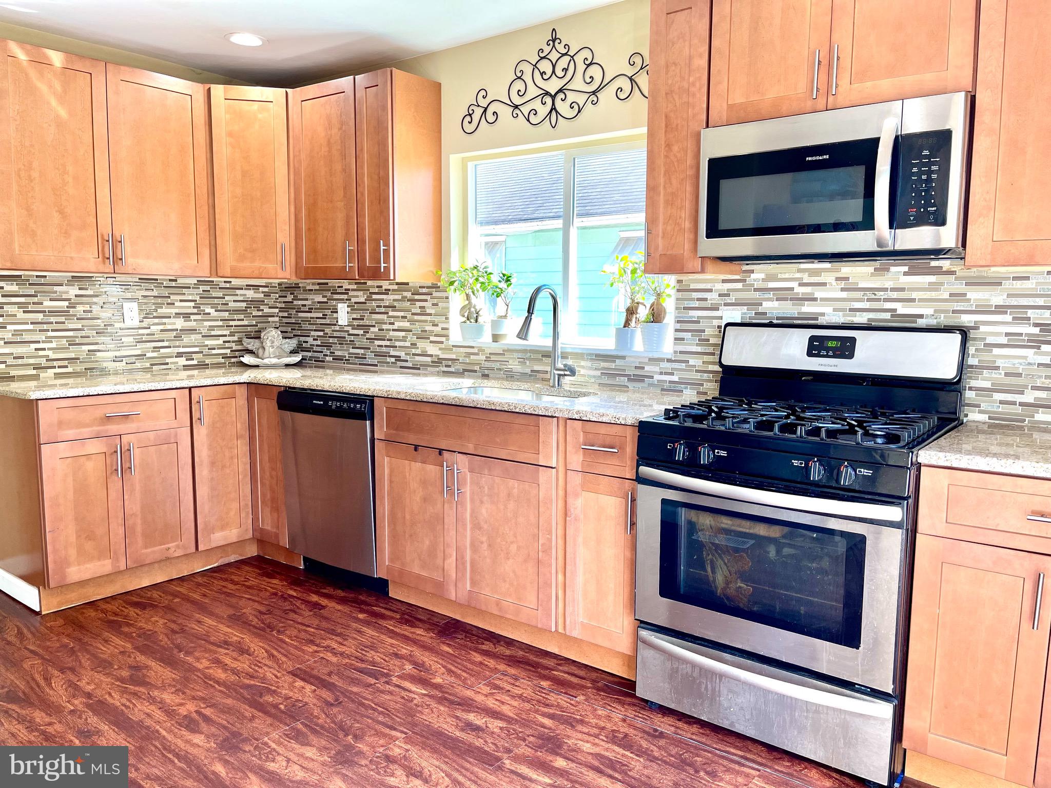 162 South Fellowship Road Maple Shade, NJ 08052 - Photo 21 of 29 a kitchen with granite countertop wooden cabinets stainless steel appliances and a window