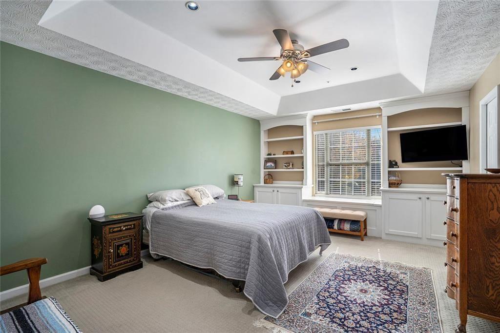 73 Whitlock Square Southwest Marietta, GA 30064 - Photo 15 of 35 a bedroom with a bed and a flat tv screen on dresser