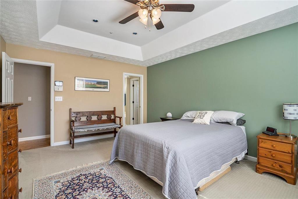 73 Whitlock Square Southwest Marietta, GA 30064 - Photo 16 of 35 a bedroom with a bed and a chandelier