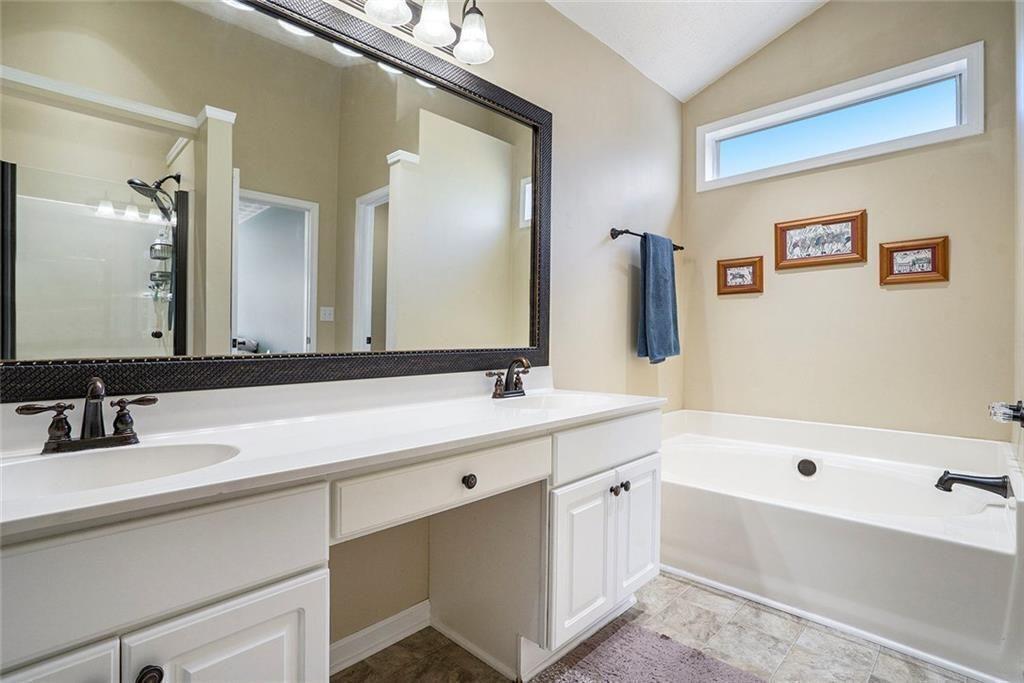 73 Whitlock Square Southwest Marietta, GA 30064 - Photo 18 of 35 a bathroom with a bathtub a double vanity sink and mirror