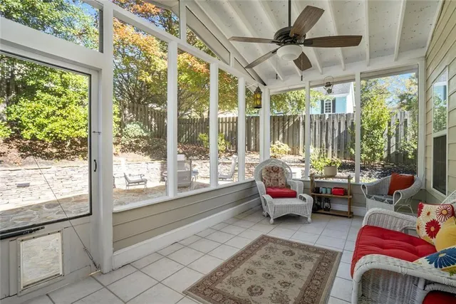 a living room with furniture and floor to ceiling windows