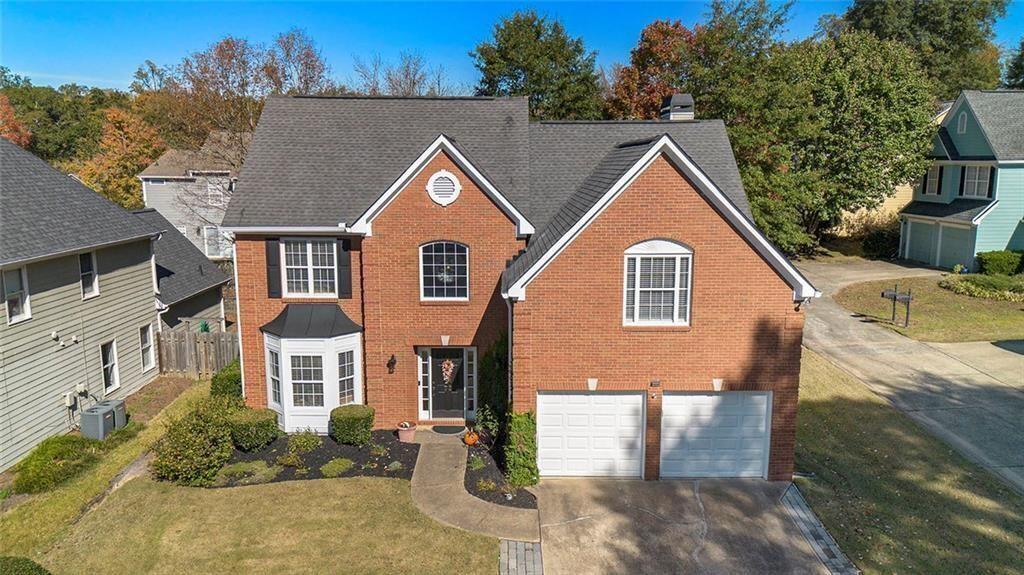 73 Whitlock Square Southwest Marietta, GA 30064 - Photo 29 of 35 a view of a brick house with a yard plants and large tree