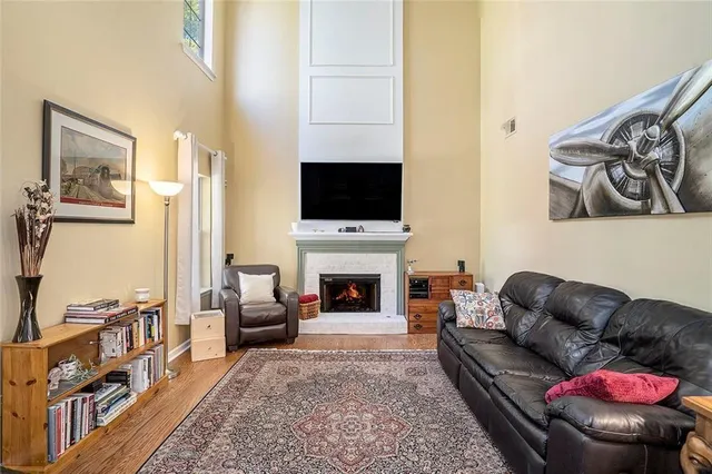 a living room with furniture a fireplace and a flat screen tv