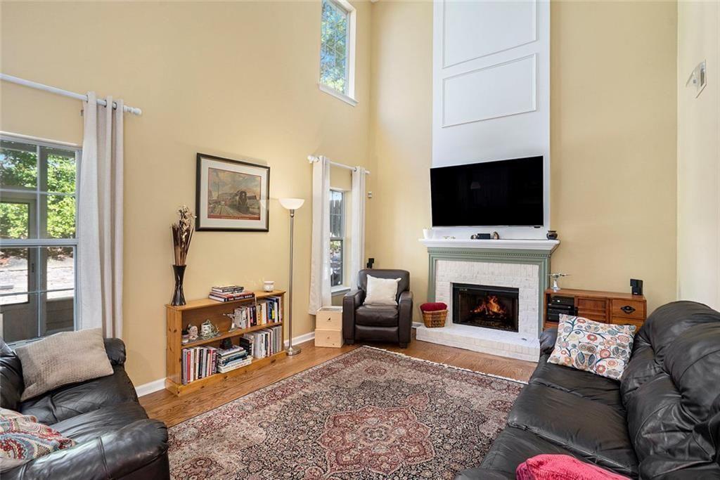 73 Whitlock Square Southwest Marietta, GA 30064 - Photo 5 of 35 a living room with furniture a flat screen tv and a fireplace