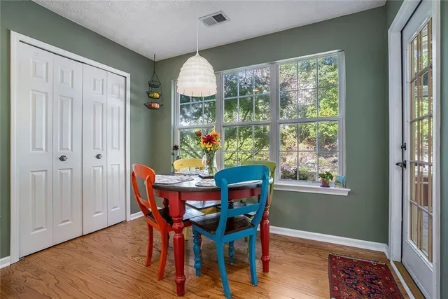 a view of a dining room with furniture window and wooden floor