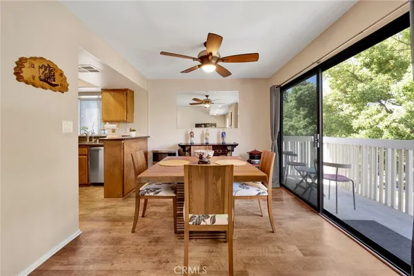 a dining room with furniture entryway and wooden floor