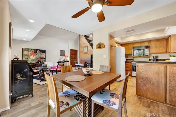 a view of a dining room and livingroom with furniture wooden floor and a rug
