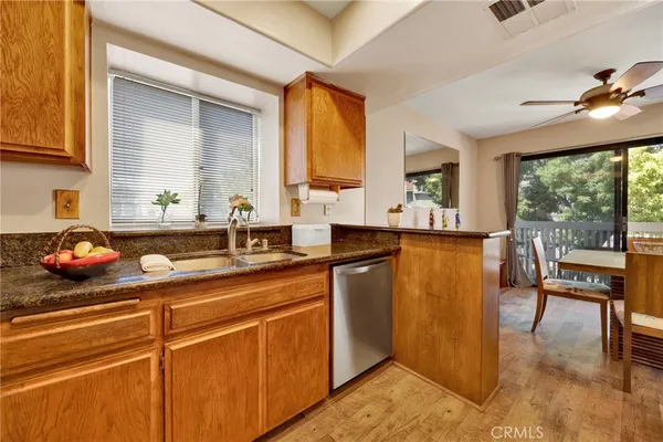 a kitchen with stainless steel appliances granite countertop a sink stove and cabinets