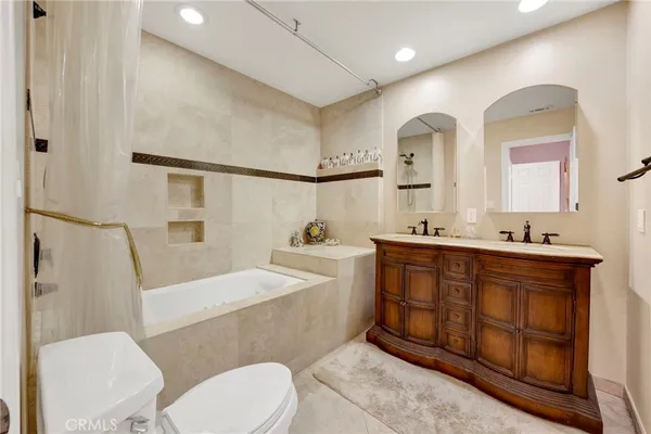 a bathroom with a sink vanity mirror and toilet