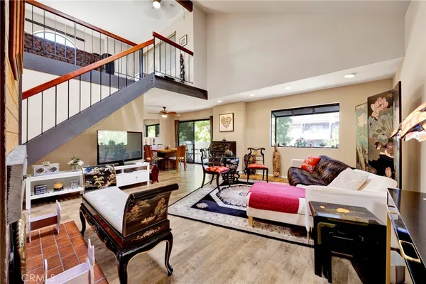 a living room with furniture a rug and a window