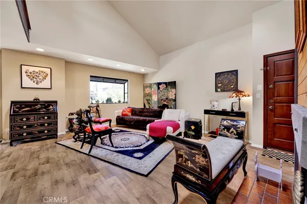 a living room with furniture a flat screen tv and a window