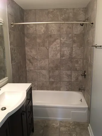 a bathroom with a bathtub and a sink