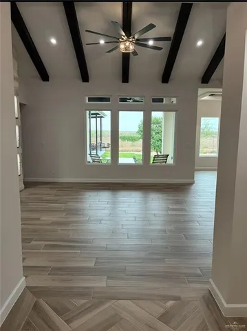 a view of room with window and ceiling fan