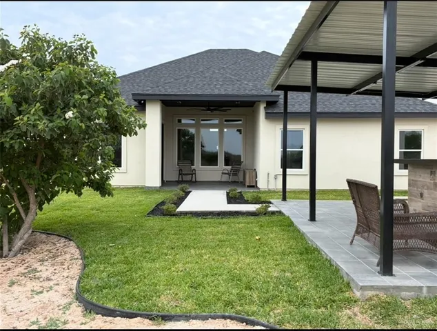 a view of a house with backyard porch and sitting area