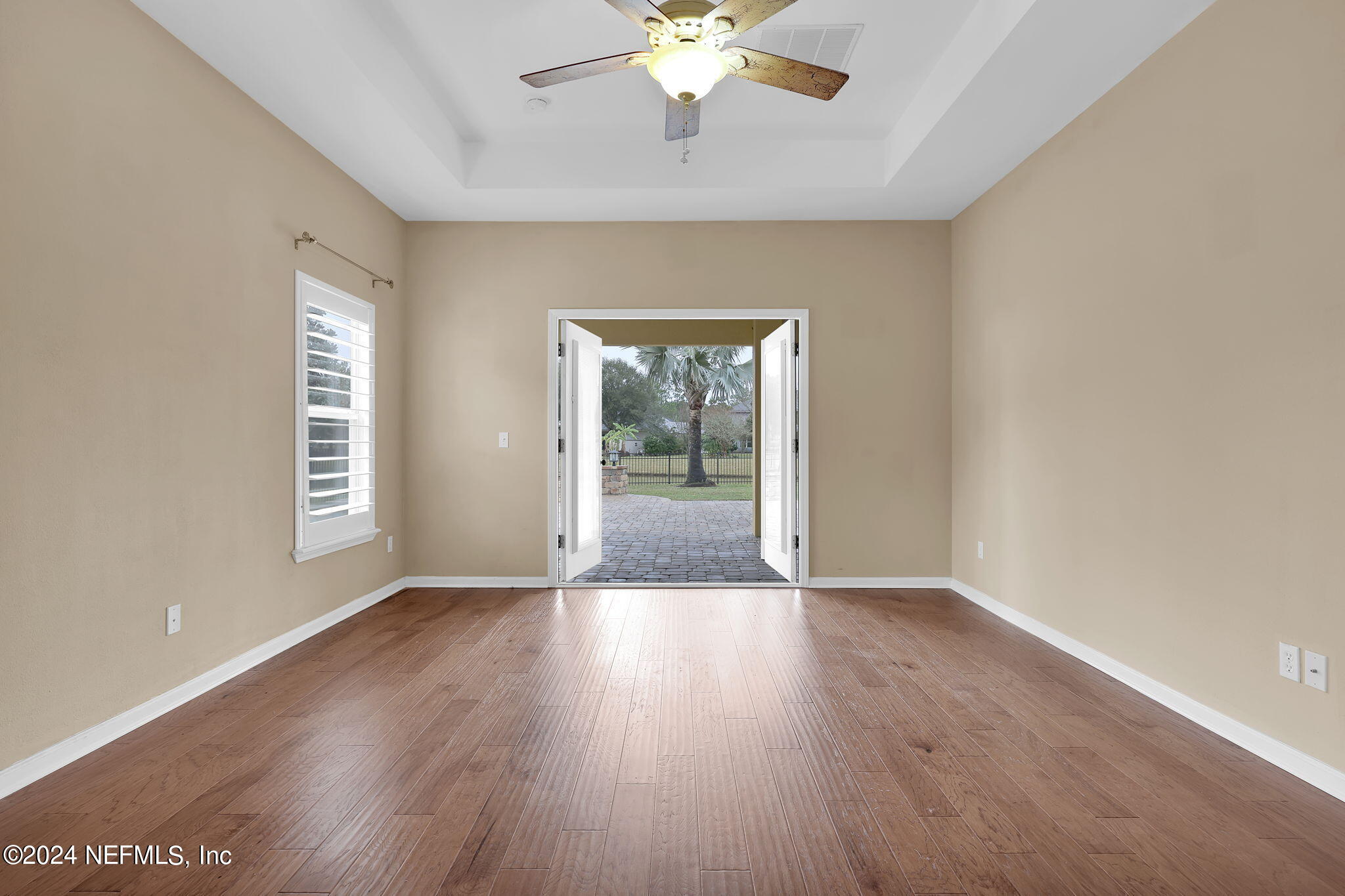 2044 River's Own Road St. Augustine, FL 32092 - Photo 17 of 48 a view of an empty room with wooden floor and a window