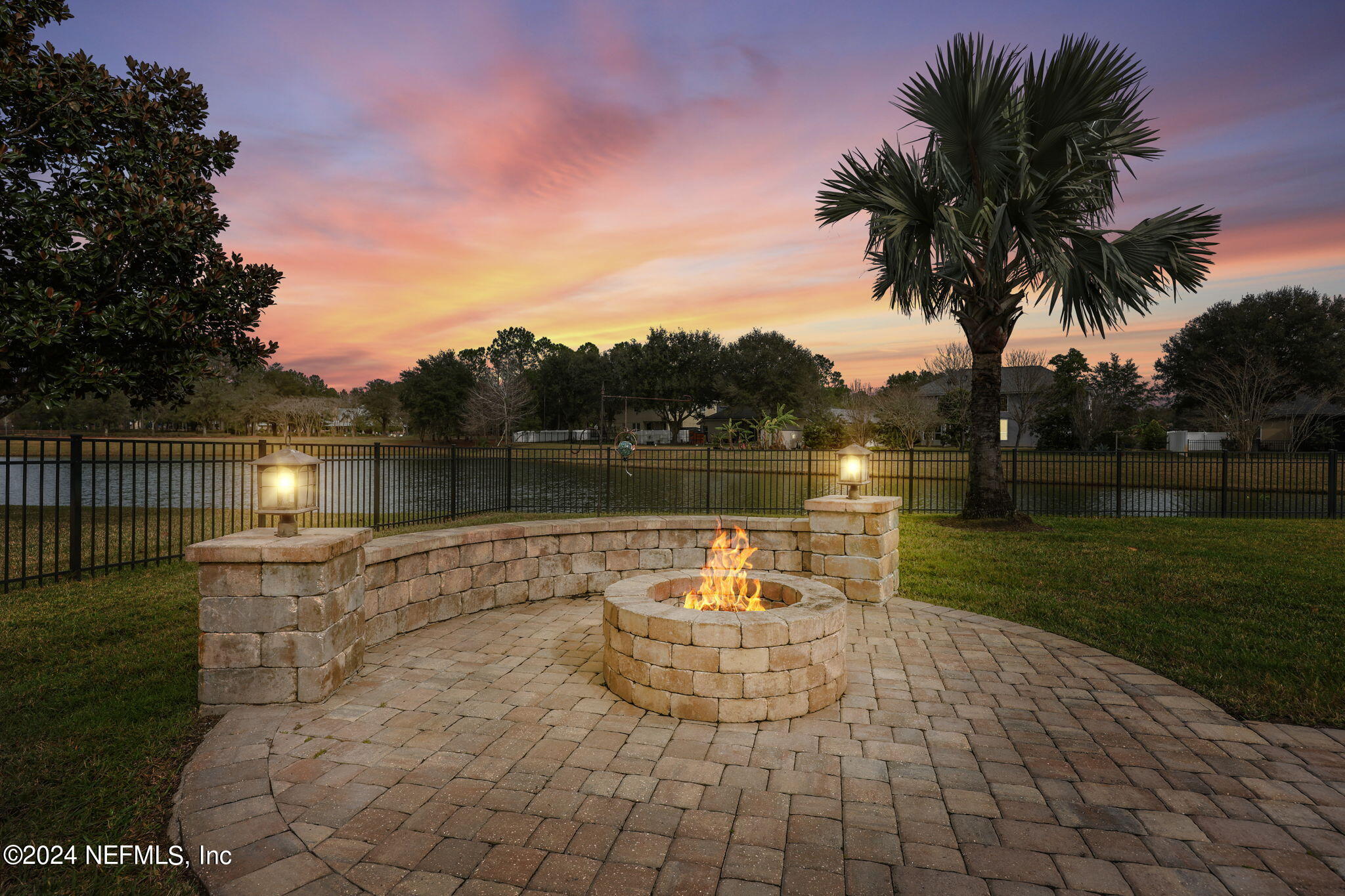 2044 River's Own Road St. Augustine, FL 32092 - Photo 26 of 48 a view of a lake with a bench and trees in the background