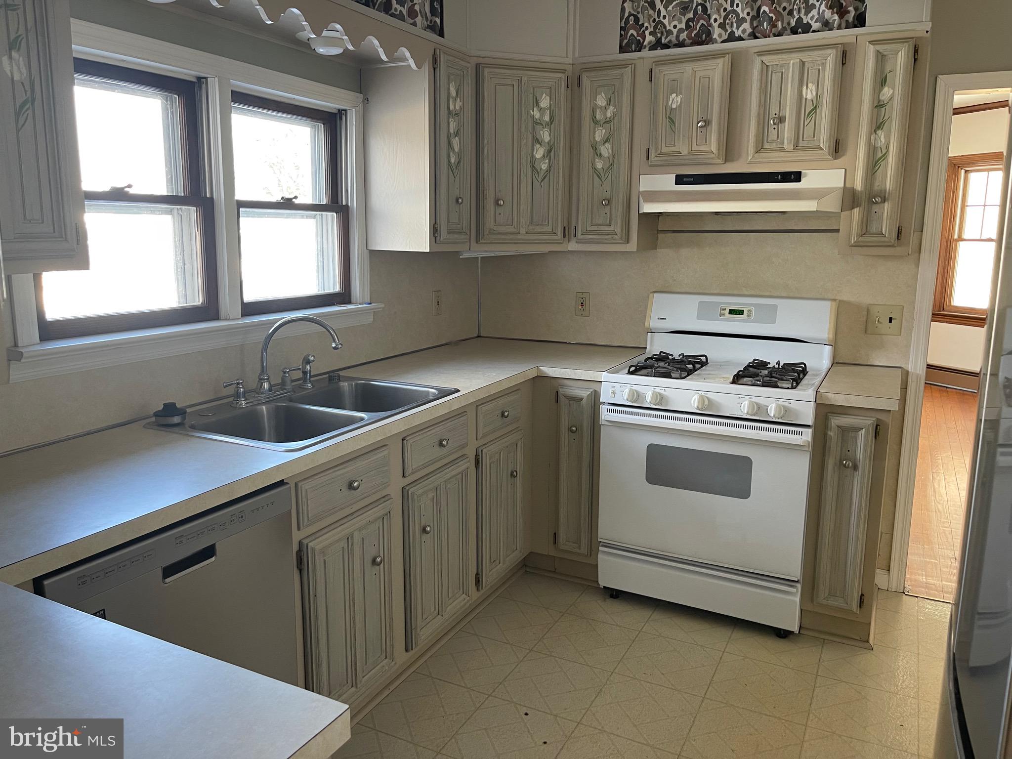 322 McKinley Avenue Pitman, NJ 08071 - Photo 13 of 44 a kitchen with cabinets appliances a sink and a window
