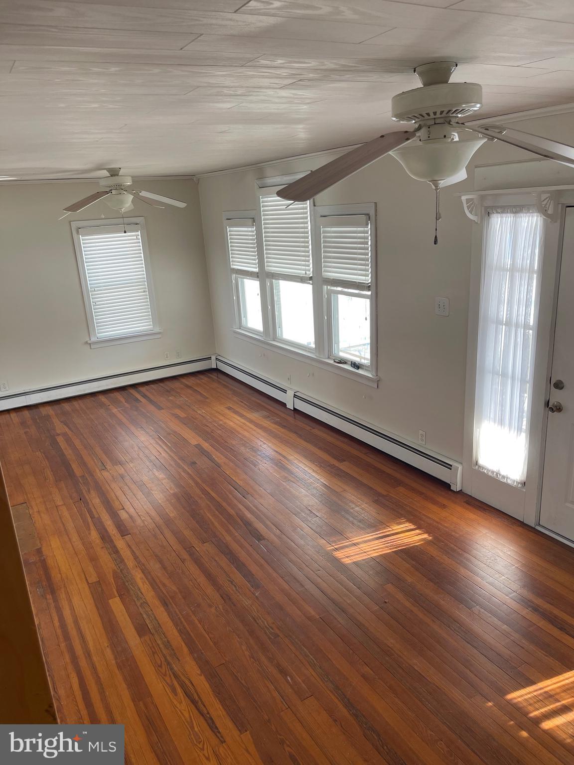 322 McKinley Avenue Pitman, NJ 08071 - Photo 20 of 44 an empty room with wooden floor and windows