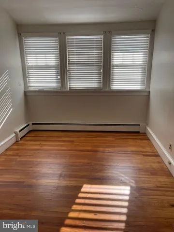 a view of a room with wooden floor and window