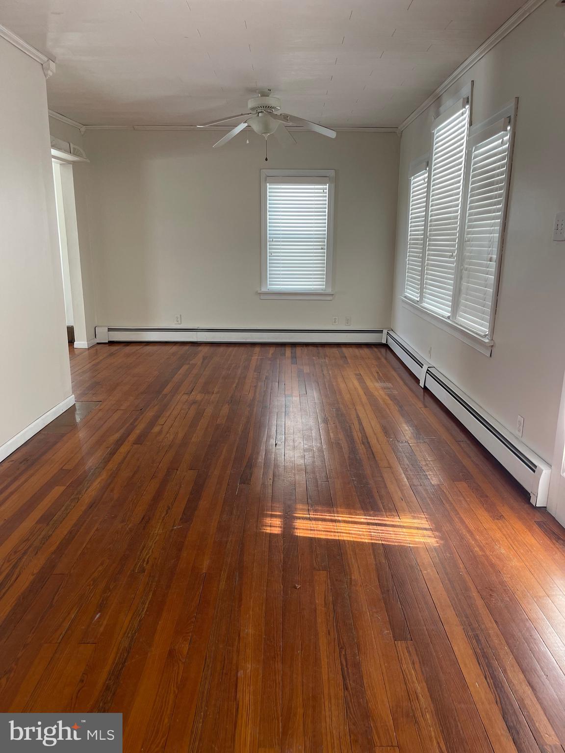 322 McKinley Avenue Pitman, NJ 08071 - Photo 5 of 44 an empty room with wooden floor and windows
