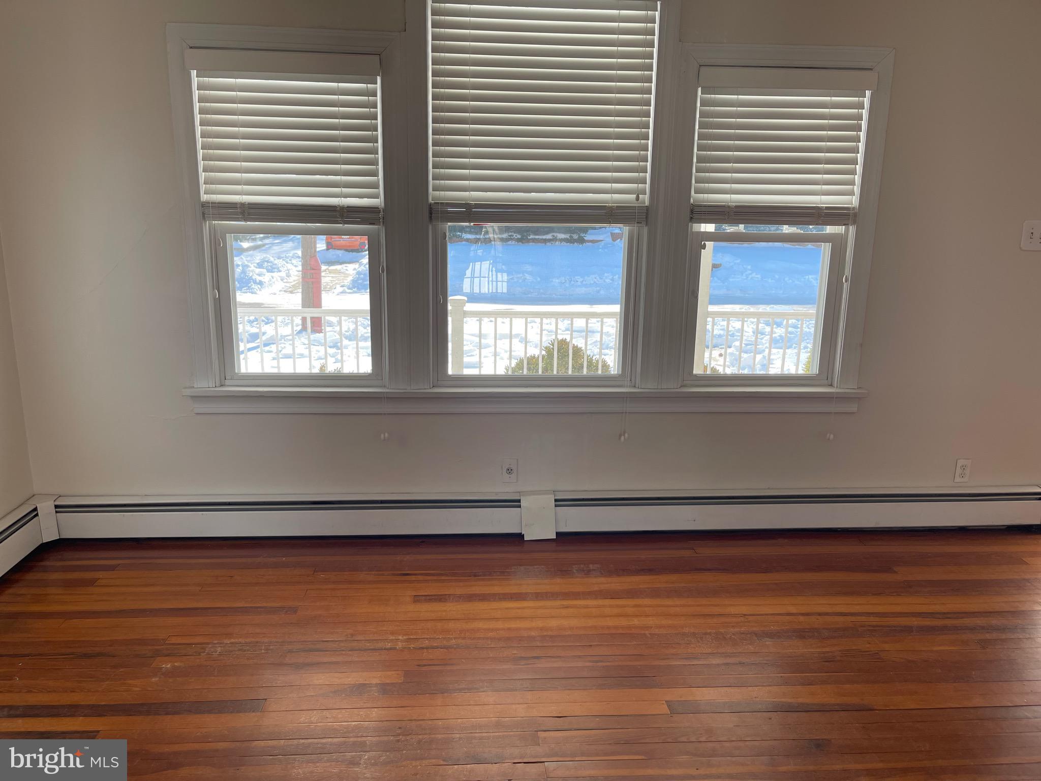 322 McKinley Avenue Pitman, NJ 08071 - Photo 6 of 44 an empty room with wooden floor and windows