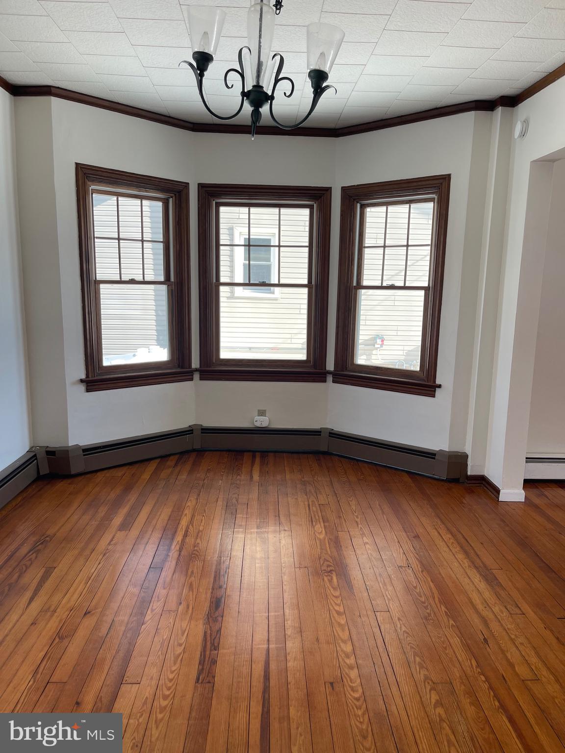 322 McKinley Avenue Pitman, NJ 08071 - Photo 10 of 44 an empty room with wooden floor and windows