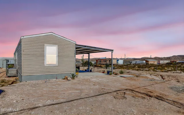 a view of a backyard with a table and chairs