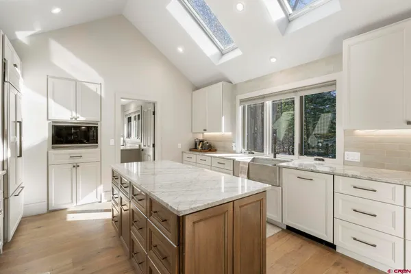 a kitchen with a stove a sink and a refrigerator
