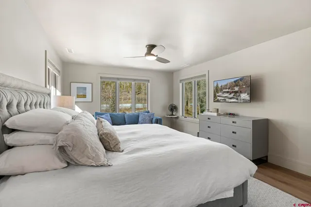 a bedroom with a large bed and a window