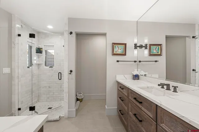 a bathroom with a granite countertop sink mirror and shower