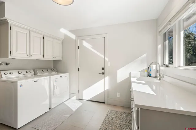 a kitchen with a sink a stove cabinets and a window