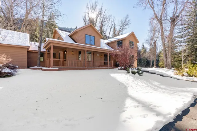 a view of a house with a snow in the yard
