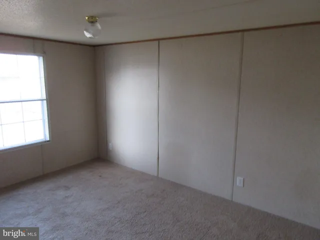 an empty room with a empty space and window