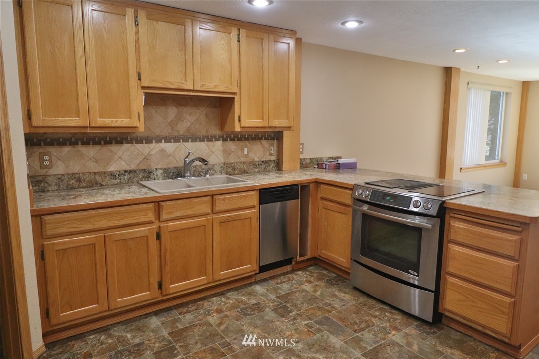 51 Quail Run Road Stevenson, WA 98648 - Photo 3 of 31 a kitchen with stainless steel appliances granite countertop a stove a sink and a microwave