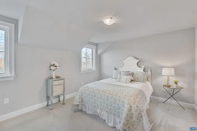 a spacious bedroom with a bed and a cabinets