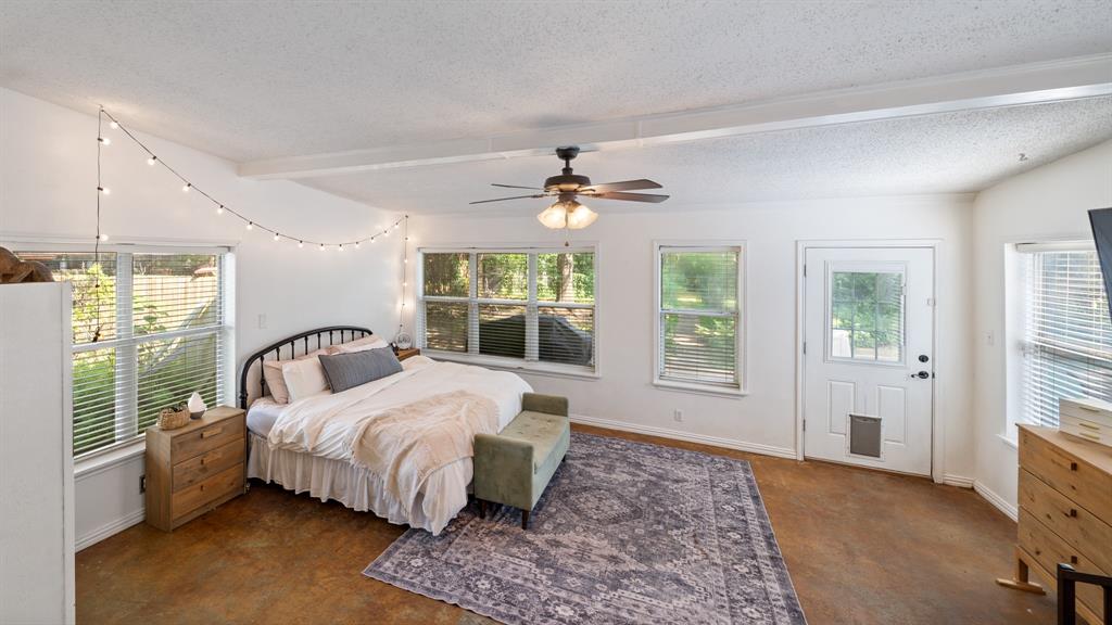 518 West Kansas Street Van, TX 75790 - Photo 13 of 24 a bedroom with a large bed and a window