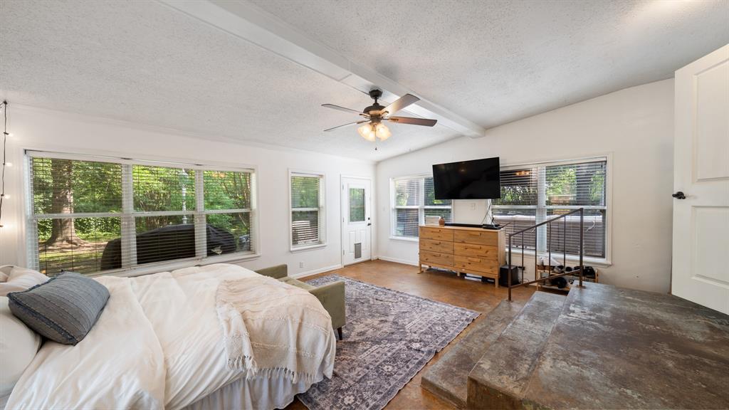 518 West Kansas Street Van, TX 75790 - Photo 15 of 24 a bedroom with a bed flat screen tv and a large window