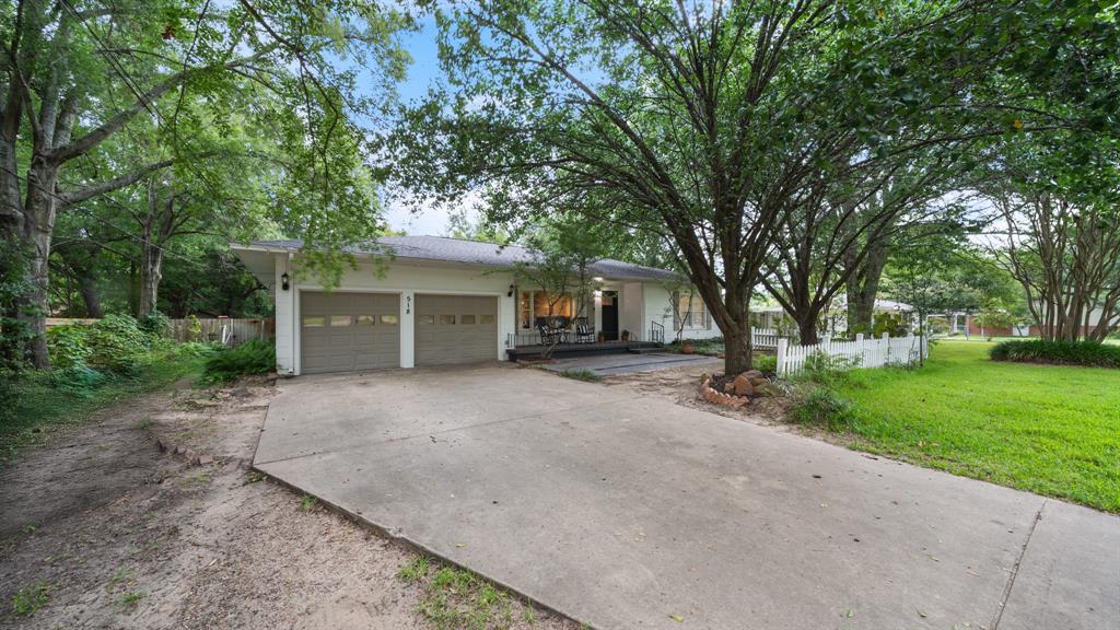 518 West Kansas Street Van, TX 75790 - Photo 2 of 24 a view of a house with a tree and a yard