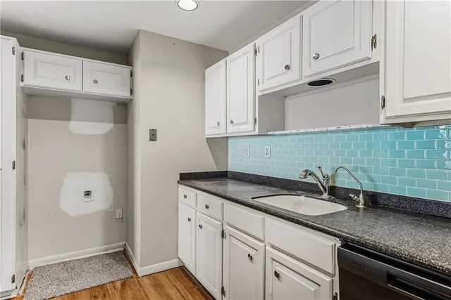 a kitchen with granite countertop a stove and a microwave