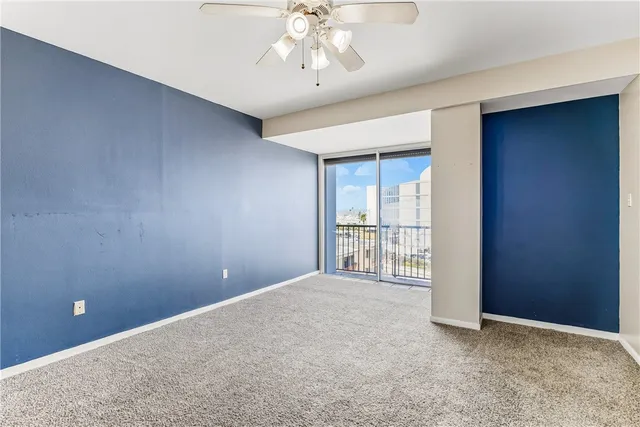 an empty room and chandelier fan