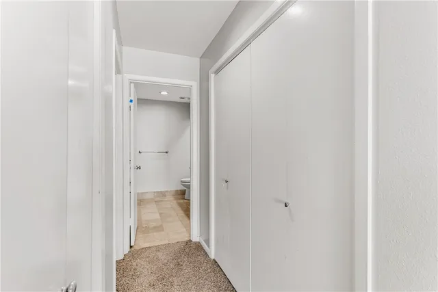 a bathroom with a granite countertop sink a toilet and a mirror
