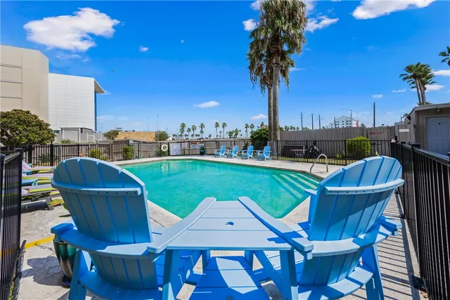 a view of a chairs and table in the patio