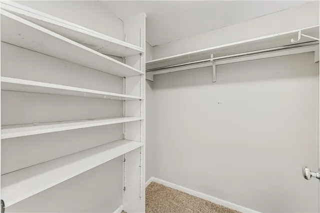 a view of a livingroom with a ceiling fan and window