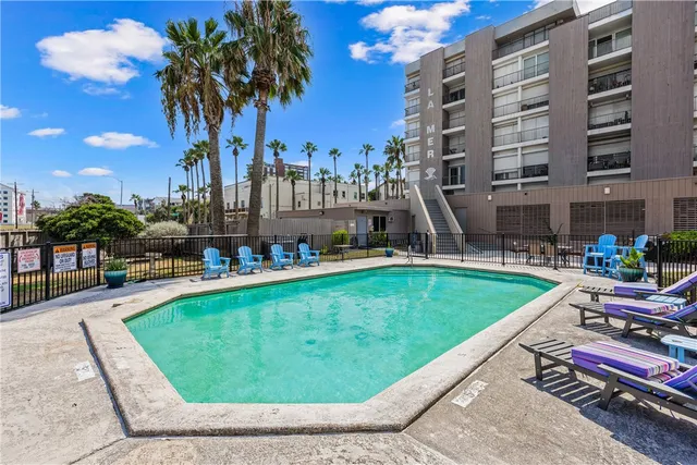 a view of a swimming pool with outdoor seating