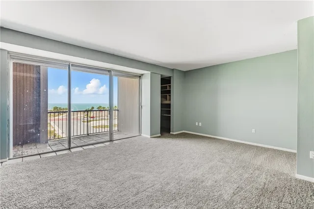 an empty room with large windows