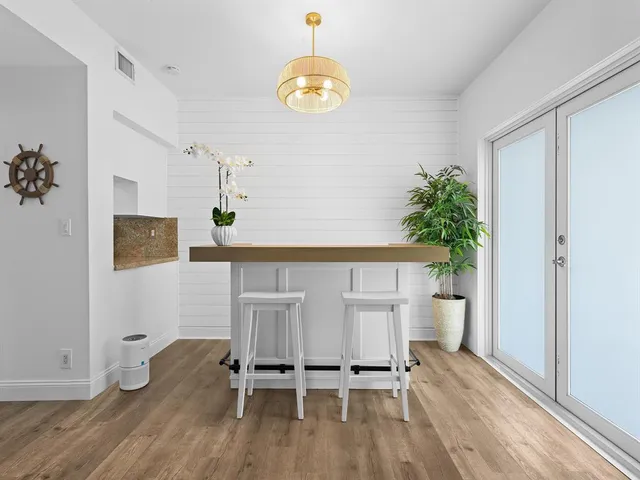 a workspace room with furniture and wooden floor