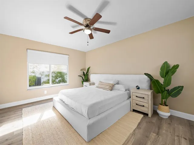 a bedroom with a large bed and a window