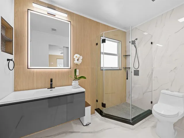 a bathroom with a sink toilet and shower